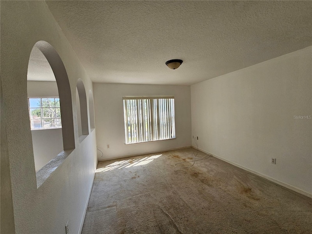 18 Fir Trail Dr, Ocala, FL 34472 - unfurnished room featuring carpet floors, arched walkways, and baseboards