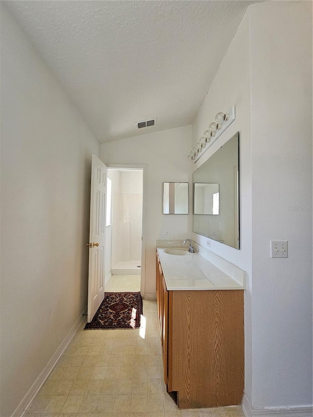 18 Fir Trail Dr, Ocala, FL 34472 - full bathroom featuring vanity, a shower, baseboards, a textured ceiling, and vaulted ceiling