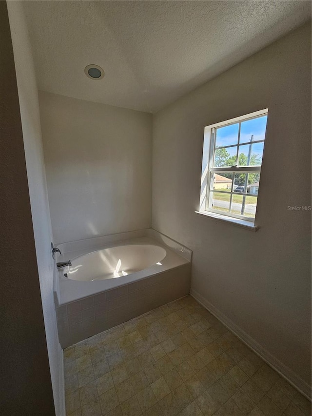 18 Fir Trail Dr, Ocala, FL 34472 - full bath featuring a garden tub, a textured ceiling, and baseboards