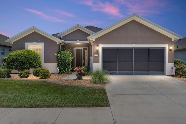 7333 SW 98th Ct, Ocala, FL 34481 - ranch-style house with an attached garage, concrete driveway, stucco siding, and a front yard