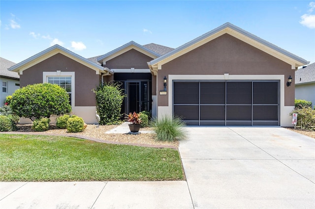 7333 SW 98th Ct, Ocala, FL 34481 - ranch-style home with a garage, driveway, stucco siding, and a front yard