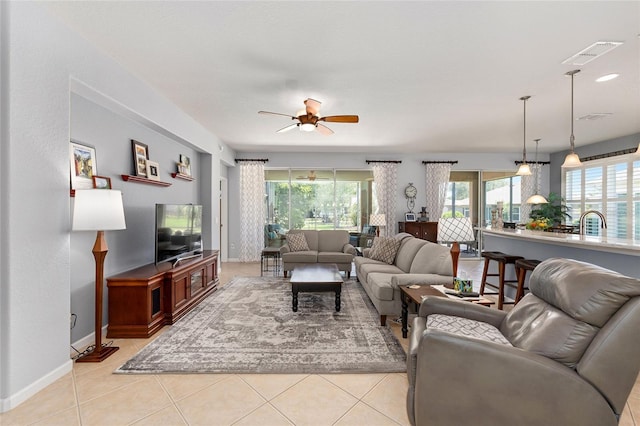 7333 SW 98th Ct, Ocala, FL 34481 - living area featuring plenty of natural light, a ceiling fan, baseboards, and light tile patterned flooring