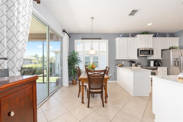 7333 SW 98th Ct, Ocala, FL 34481 - kitchen featuring appliances with stainless steel finishes, light countertops, white cabinets, backsplash, and recessed lighting