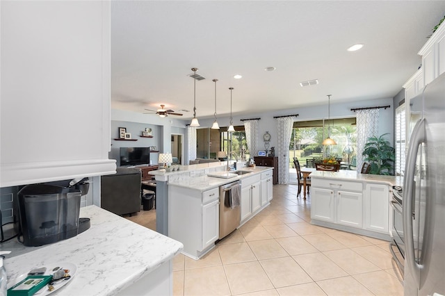 7333 SW 98th Ct, Ocala, FL 34481 - kitchen featuring appliances with stainless steel finishes, open floor plan, white cabinetry, hanging light fixtures, and recessed lighting