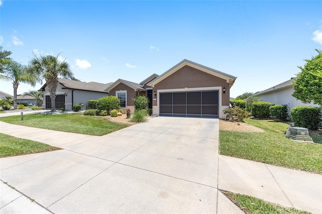 7333 SW 98th Ct, Ocala, FL 34481 - ranch-style house with an attached garage, concrete driveway, stucco siding, and a front yard