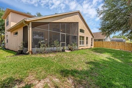 2434 Walnut Heights Rd, Apopka, FL 32703 - rear view of property with a sunroom and stucco siding
