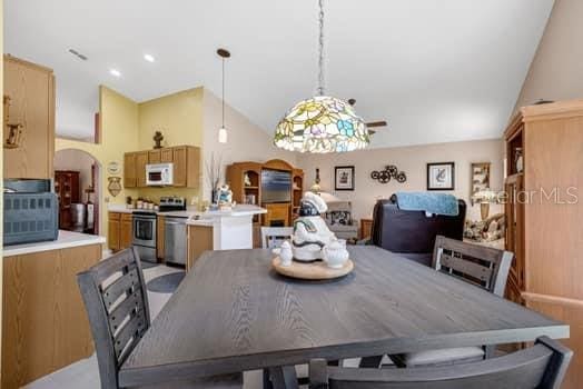 2434 Walnut Heights Rd, Apopka, FL 32703 - dining space featuring vaulted ceiling and arched walkways
