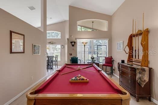 2434 Walnut Heights Rd, Apopka, FL 32703 - playroom featuring pool table, baseboards, healthy amount of natural light, carpet, and high vaulted ceiling