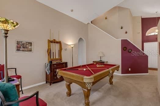 2434 Walnut Heights Rd, Apopka, FL 32703 - recreation room with carpet floors, billiards table, baseboards, and arched walkways