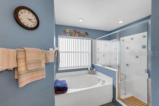 2434 Walnut Heights Rd, Apopka, FL 32703 - bathroom with a shower stall and a garden tub