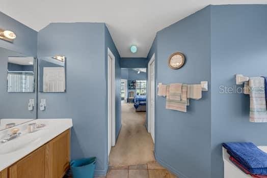 2434 Walnut Heights Rd, Apopka, FL 32703 - bathroom with vanity, tile patterned floors, and baseboards