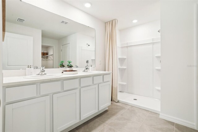 2153 NE 28th Ln, Ocala, FL 34470 - bathroom with tile patterned floors, a shower stall, double vanity, and a spacious closet