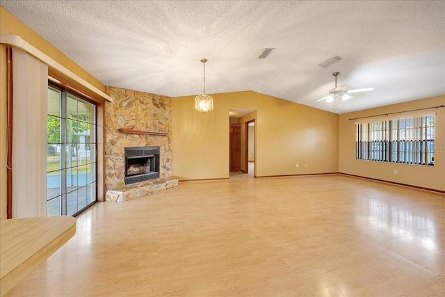 4331 SE 106th Pl, Belleview, FL 34420 - unfurnished living room featuring light wood-style flooring, vaulted ceiling, healthy amount of natural light, a textured ceiling, and baseboards
