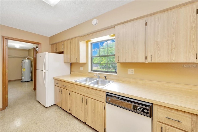 4331 SE 106th Pl, Belleview, FL 34420 - kitchen featuring white appliances, light brown cabinets, a sink, and water heater
