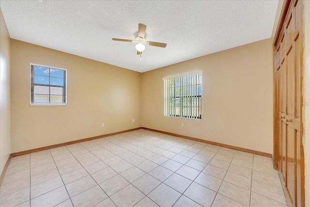 4331 SE 106th Pl, Belleview, FL 34420 - spare room with plenty of natural light, a ceiling fan, a textured ceiling, and baseboards