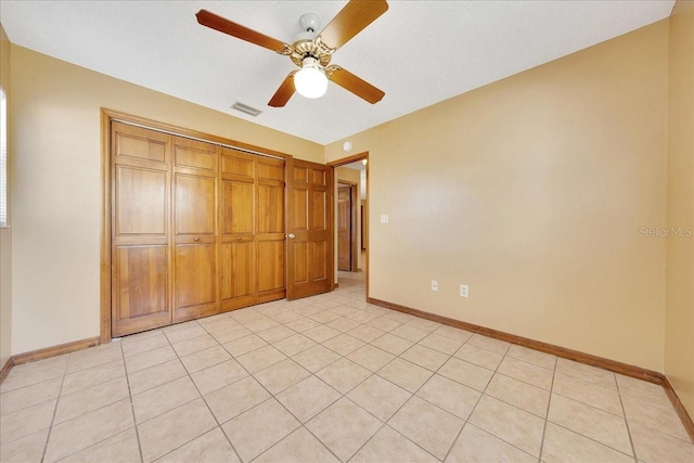 4331 SE 106th Pl, Belleview, FL 34420 - unfurnished bedroom featuring baseboards, a closet, ceiling fan, and light tile patterned floors