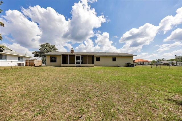 4331 SE 106th Pl, Belleview, FL 34420 - back of property with a sunroom, cooling unit, and a chimney