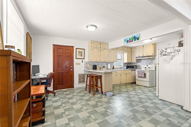 1405 NE 55th St, Ocala, FL 34479 - kitchen with white electric range oven, light countertops, a breakfast bar, a desk, and stainless steel microwave