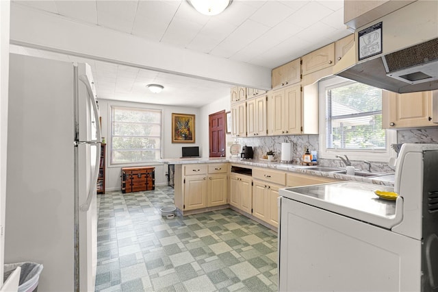 1405 NE 55th St, Ocala, FL 34479 - kitchen with freestanding refrigerator, a peninsula, a sink, and plenty of natural light