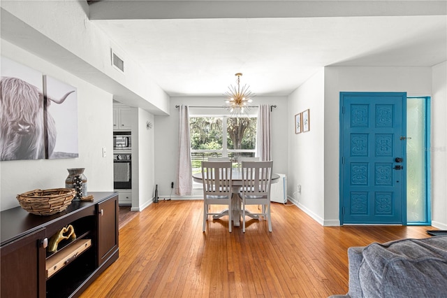 2475 SW 7th Ave, Ocala, FL 34471 - dining room with light wood finished floors, baseboards, and a chandelier