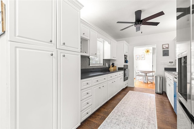 2475 SW 7th Ave, Ocala, FL 34471 - kitchen with black appliances, a ceiling fan, dark countertops, and white cabinetry