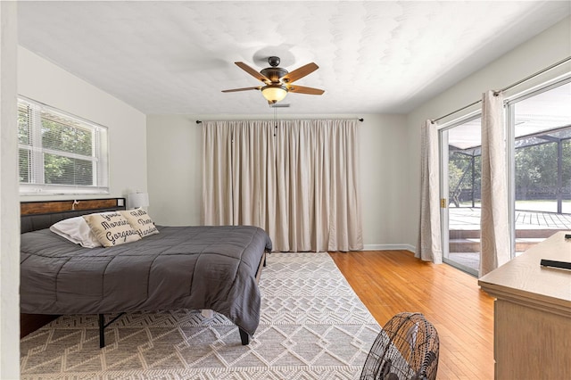 2475 SW 7th Ave, Ocala, FL 34471 - bedroom with light wood-style flooring, access to exterior, multiple windows, and baseboards