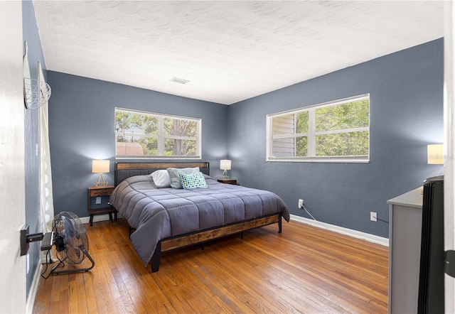 2475 SW 7th Ave, Ocala, FL 34471 - bedroom with multiple windows, wood-type flooring, baseboards, and a textured ceiling