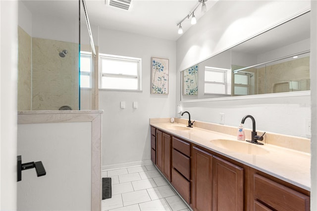 2475 SW 7th Ave, Ocala, FL 34471 - bathroom featuring a walk in shower, double vanity, tile patterned floors, and baseboards