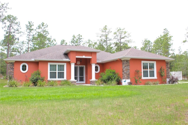 5306 W Comstock Pl, Beverly Hills, FL 34465 - prairie-style house with stucco siding, a front yard, and stone siding