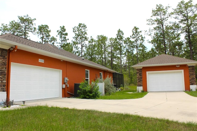 5306 W Comstock Pl, Beverly Hills, FL 34465 - view of property exterior with stucco siding, a garage, stone siding, and a yard