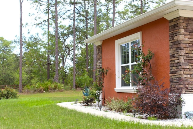 5306 W Comstock Pl, Beverly Hills, FL 34465 - view of side of home featuring stucco siding, stone siding, and a yard