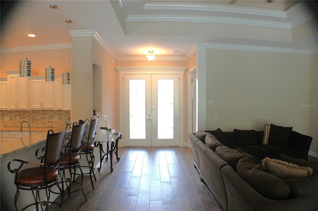 5306 W Comstock Pl, Beverly Hills, FL 34465 - foyer with french doors, light wood-style flooring, baseboards, a raised ceiling, and ornamental molding
