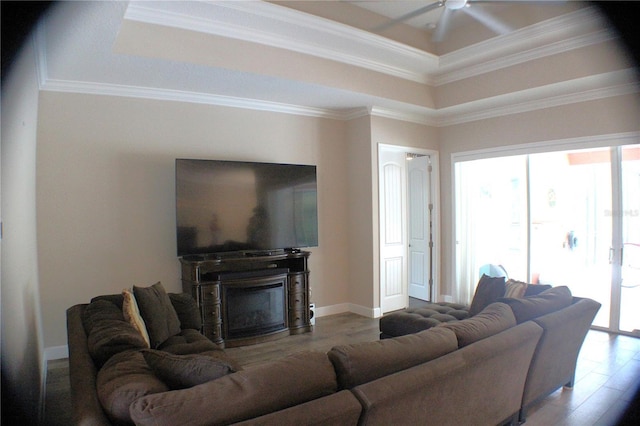 5306 W Comstock Pl, Beverly Hills, FL 34465 - living area with a tray ceiling, a ceiling fan, a fireplace, crown molding, and baseboards