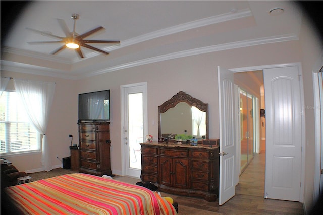 5306 W Comstock Pl, Beverly Hills, FL 34465 - bedroom featuring a raised ceiling, crown molding, wood finished floors, and baseboards