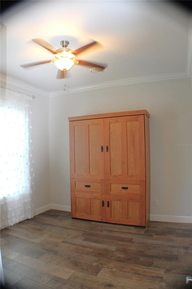 5306 W Comstock Pl, Beverly Hills, FL 34465 - unfurnished bedroom featuring dark wood-style flooring, ornamental molding, baseboards, and a ceiling fan