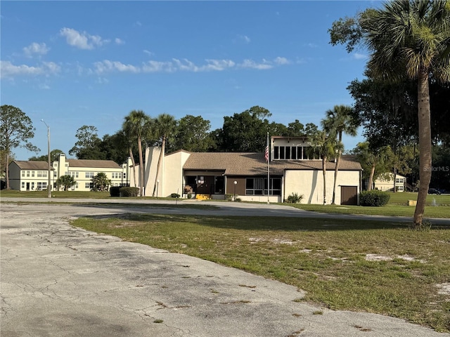 13201 Sandalwood Dr Unit 201, Wildwood, FL 34785 - view of front of property featuring stucco siding and a front lawn