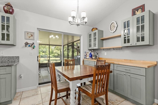 14131 SE 86th Ter, Inglis, FL 34449 - dining room with a chandelier, baseboards, and light tile patterned floors