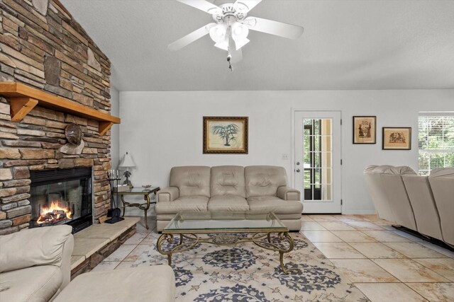 14131 SE 86th Ter, Inglis, FL 34449 - living room featuring ceiling fan, lofted ceiling, a fireplace, and tile patterned flooring