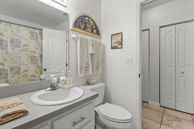 14131 SE 86th Ter, Inglis, FL 34449 - bathroom featuring a closet, vanity, toilet, and tile patterned flooring