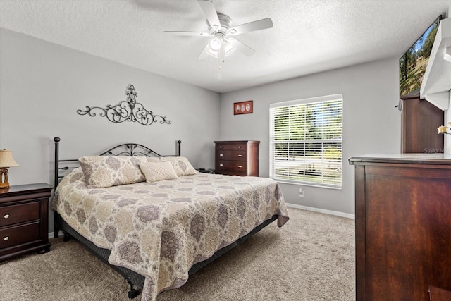 14131 SE 86th Ter, Inglis, FL 34449 - carpeted bedroom with baseboards, a textured ceiling, and a ceiling fan