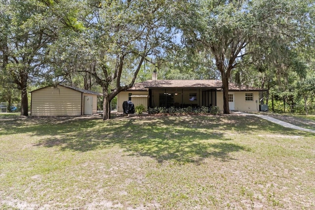 14131 SE 86th Ter, Inglis, FL 34449 - view of front facade with a front yard and a chimney