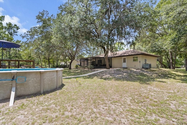14131 SE 86th Ter, Inglis, FL 34449 - view of green lawn featuring an outdoor pool and central air condition unit