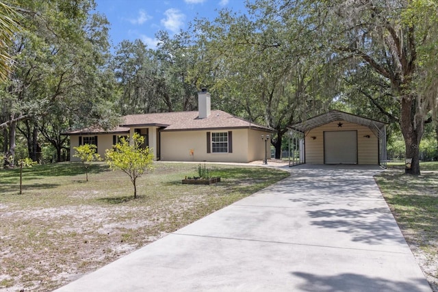 14131 SE 86th Ter, Inglis, FL 34449 - single story home with a chimney, an outdoor structure, a garage, a front yard, and stucco siding