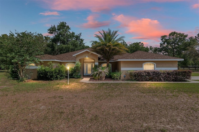 12495 SW 66th St, Ocala, FL 34481 - ranch-style house with a front yard and stucco siding