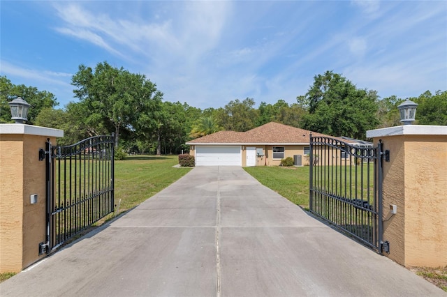 12495 SW 66th St, Ocala, FL 34481 - view of front facade with a gate, a front yard, and concrete driveway