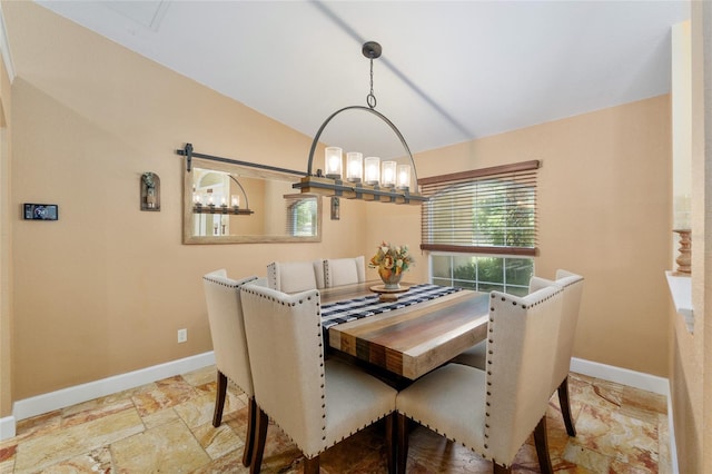 12495 SW 66th St, Ocala, FL 34481 - dining room featuring a chandelier, baseboards, lofted ceiling, and stone finish flooring