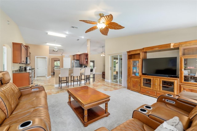 12495 SW 66th St, Ocala, FL 34481 - living area featuring ceiling fan, vaulted ceiling, arched walkways, and baseboards