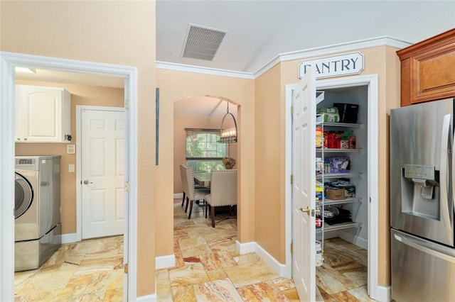 12495 SW 66th St, Ocala, FL 34481 - laundry area featuring cabinet space, washer / dryer, ornamental molding, arched walkways, and baseboards