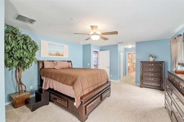 12495 SW 66th St, Ocala, FL 34481 - bedroom with light colored carpet, baseboards, ensuite bath, and ceiling fan