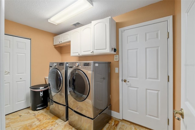 12495 SW 66th St, Ocala, FL 34481 - laundry room featuring washer and clothes dryer, cabinet space, and a textured ceiling